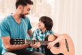 Young Bearded Father Playing on Guitar with Son.