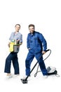 Young bearded handsome guy and a girl in a uniform of cleaners are isolated on a white background. In the hands of a bucket with Royalty Free Stock Photo