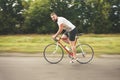 Young bearded hipster driving bicycle