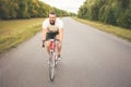 Young bearded hipster driving bicycle