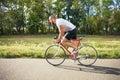 Young bearded hipster driving fast bicycle