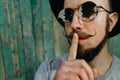Hipster man gesture for silence showing hush sign Royalty Free Stock Photo
