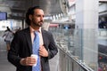 Young bearded Indian businessman relaxing around the city Royalty Free Stock Photo