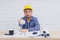 Engineer or Architect sitting, working at his desk in the office