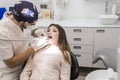 Young bearded male dentist drilling tooth to female patient Royalty Free Stock Photo