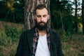 A young bearded man closed his eyes resting and dreaming in the woods. The concept of unity with nature Royalty Free Stock Photo