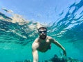 Young bearded man diving in a blue clean water Royalty Free Stock Photo