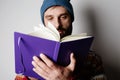 Young bearded man holding hand note book.