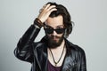 Young bearded man in leather. Hipster in sunglasses Royalty Free Stock Photo