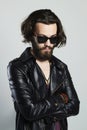 Young bearded man in leather. Hipster in sunglasses Royalty Free Stock Photo