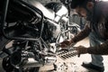 Man with motorcycle in garage