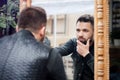 Young man looks at himself in the mirror Royalty Free Stock Photo