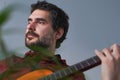 young bearded man playing the Spanish guitar Royalty Free Stock Photo