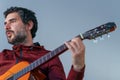 young bearded man playing the Spanish guitar Royalty Free Stock Photo