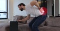 Young bearded man with spinal problems bends over with back pain at home, digital 3d animation with red pulsating sore