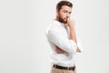 Young bearded man standing over white wall Royalty Free Stock Photo