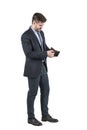 Young bearded man in suit looking inside his empty wallet Royalty Free Stock Photo