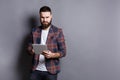 Young bearded man using tablet computer Royalty Free Stock Photo