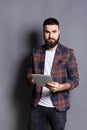 Young bearded man using tablet computer Royalty Free Stock Photo