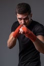 Sporty man with hands wraps standing in orthodox fighting stance Royalty Free Stock Photo
