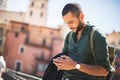 Young bearded traveller using his smartphone Royalty Free Stock Photo