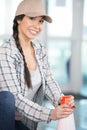 young beatiful cute girl holding orange plastic road cone