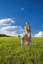 Young beatiful girl in green field