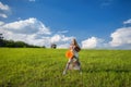 Young beatiful girl in green field