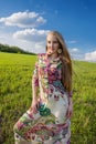 Young beatiful girl in green field