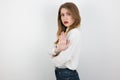 Young beatuiful blond woman showing stop sign on isolated white background, body language