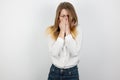 Young beatuiful blond woman sneezing on isolated white background, healthcare and medical