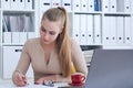 Young beauiful Caucasian businesswoman working on notebook computer and business document at office.