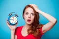 Young beautfiul redhead girl with alarm clock Royalty Free Stock Photo