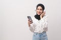 Young beautifu musliml woman wearing headset on white background