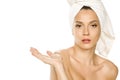 Young beautiful advertizing woman with towel on her head