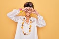 Young beautiful african american afro hippie woman wearing sunglasses and accessories Doing heart shape with hand and fingers