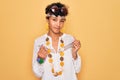 Young beautiful african american afro hippie woman wearing sunglasses and accessories doing money gesture with hands, asking for