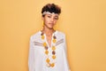 Young beautiful african american afro hippie woman wearing sunglasses and accessories looking sleepy and tired, exhausted for