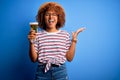 Young beautiful African American afro woman with curly hair on vacation drinking glass of beer very happy and excited, winner Royalty Free Stock Photo