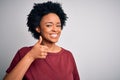 Young beautiful African American afro woman with curly hair wearing casual t-shirt standing doing happy thumbs up gesture with Royalty Free Stock Photo