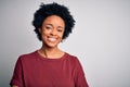 Young beautiful African American afro woman with curly hair wearing casual t-shirt standing happy face smiling with crossed arms Royalty Free Stock Photo