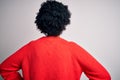 Young beautiful African American afro woman with curly hair wearing red casual sweater standing backwards looking away with arms Royalty Free Stock Photo