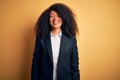 Young beautiful african american business woman with afro hair wearing elegant jacket with a happy and cool smile on face Royalty Free Stock Photo