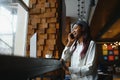 Young beautiful African-American business woman talking on the phone while working in a cafe Royalty Free Stock Photo