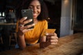 Young girl chatting while paying bill at coffee shop.