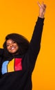 Young beautiful african american girl with an afro hairstyle. Portrait on yellow background. Royalty Free Stock Photo