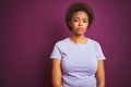 Young beautiful african american woman with afro hair over isolated purple background Relaxed with serious expression on face Royalty Free Stock Photo