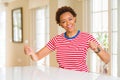 Young beautiful african american woman at home Dancing happy and cheerful, smiling moving casual and confident listening to music Royalty Free Stock Photo