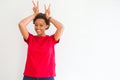 Young beautiful african american woman over white background Posing funny and crazy with fingers on head as bunny ears, smiling Royalty Free Stock Photo