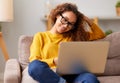 Smiling african american young woman using laptop while working remotely or studying online from home Royalty Free Stock Photo